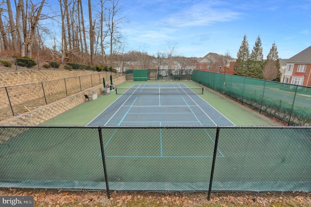 view of sport court featuring fence