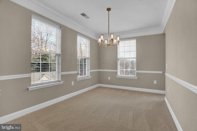 carpeted spare room with baseboards, visible vents, a notable chandelier, and ornamental molding