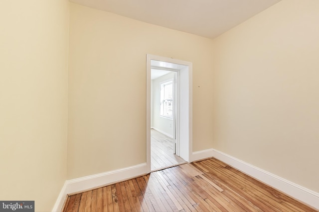 spare room with light wood finished floors and baseboards