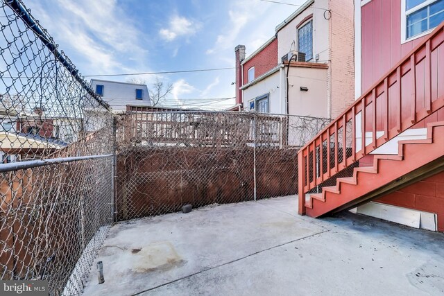 snow covered patio featuring fence