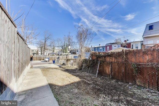 view of yard with a residential view and fence