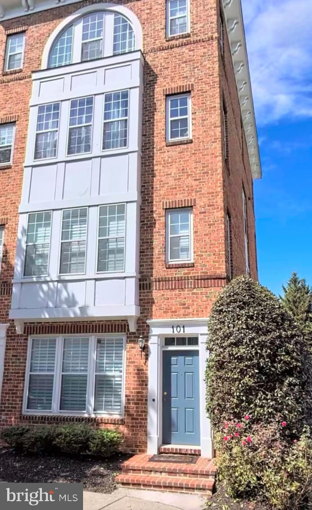 exterior space with brick siding