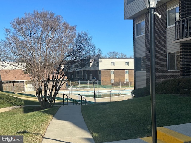 view of property's community featuring a lawn