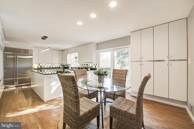 dining room featuring light wood-style flooring and recessed lighting