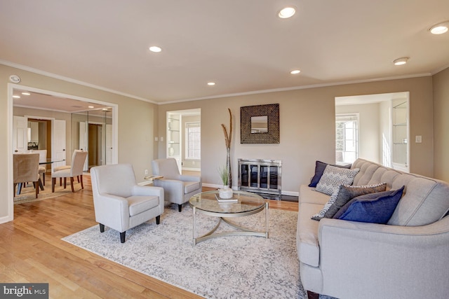 living room with baseboards, recessed lighting, wood finished floors, and crown molding