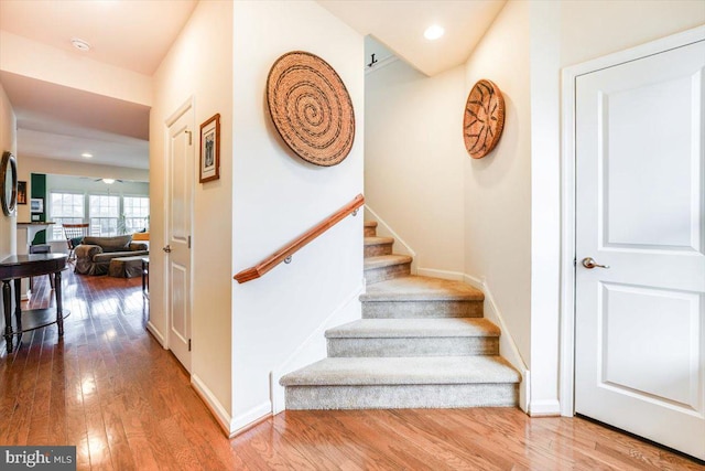 stairs featuring recessed lighting, wood-type flooring, and baseboards