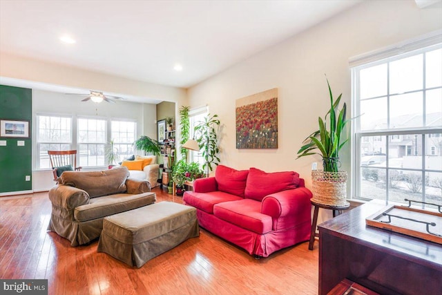 living area featuring wood-type flooring, baseboards, ceiling fan, and recessed lighting