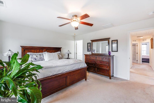 bedroom featuring light carpet, visible vents, a ceiling fan, and baseboards