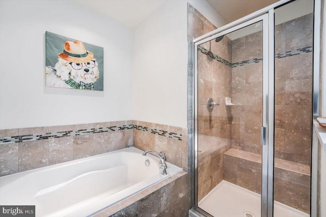 full bath featuring a shower stall and a bath