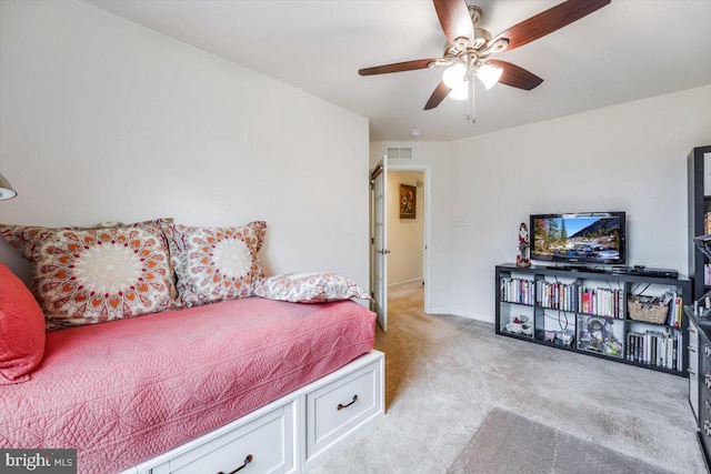 bedroom with light carpet, baseboards, visible vents, and a ceiling fan