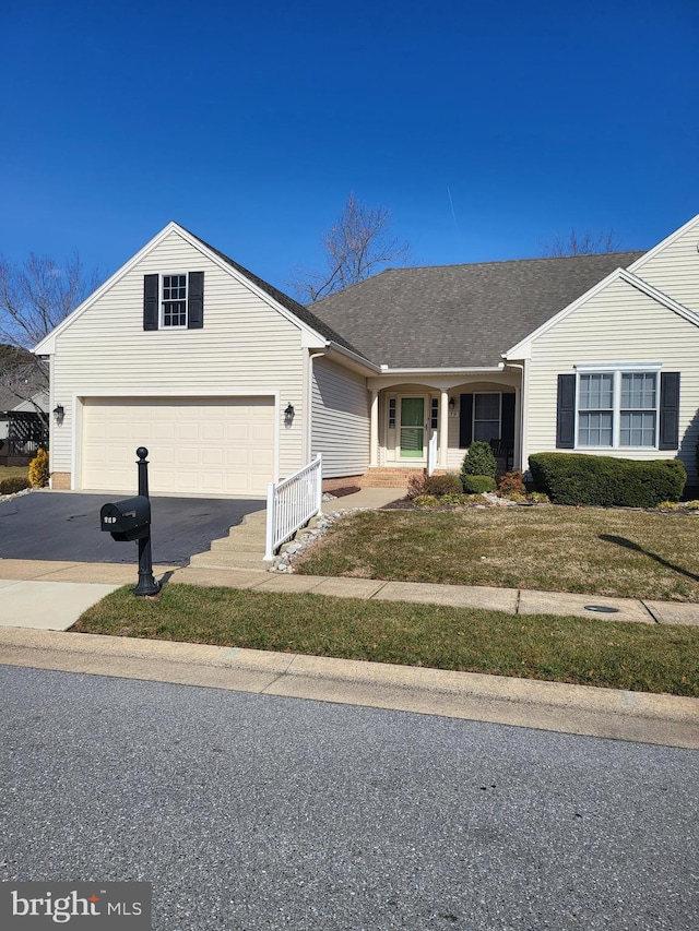 single story home with a garage, driveway, and a shingled roof