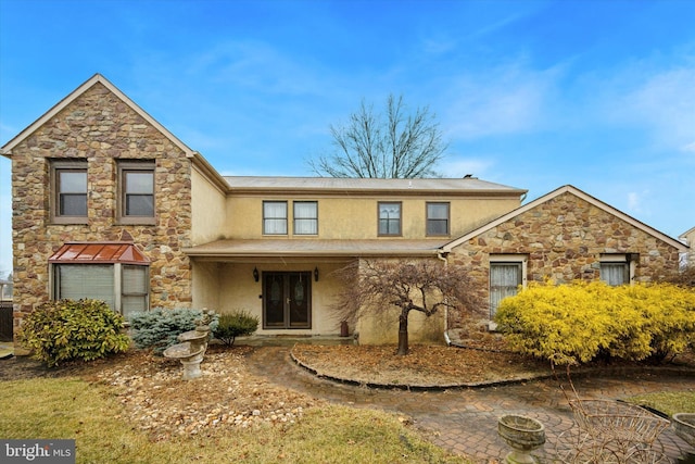 view of front of property featuring french doors and stucco siding