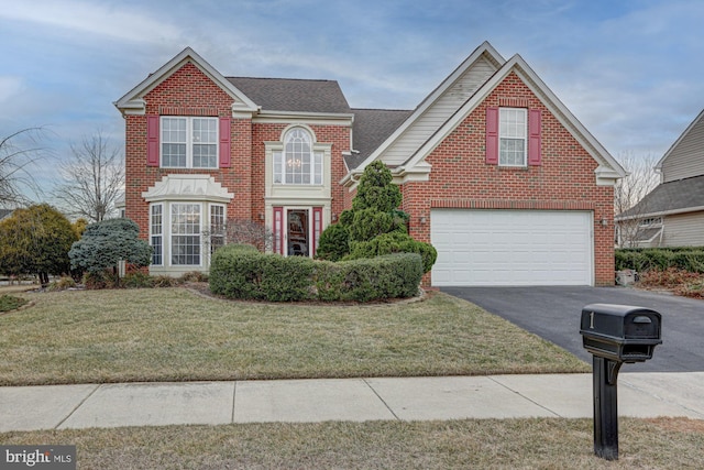 traditional home with a garage, aphalt driveway, roof with shingles, a front lawn, and brick siding