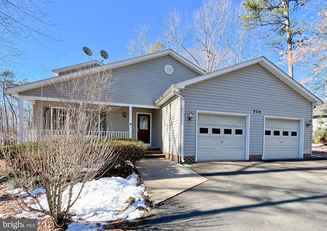 view of front of house featuring a garage and a porch