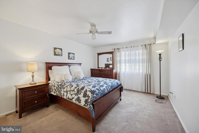 bedroom featuring light carpet and ceiling fan