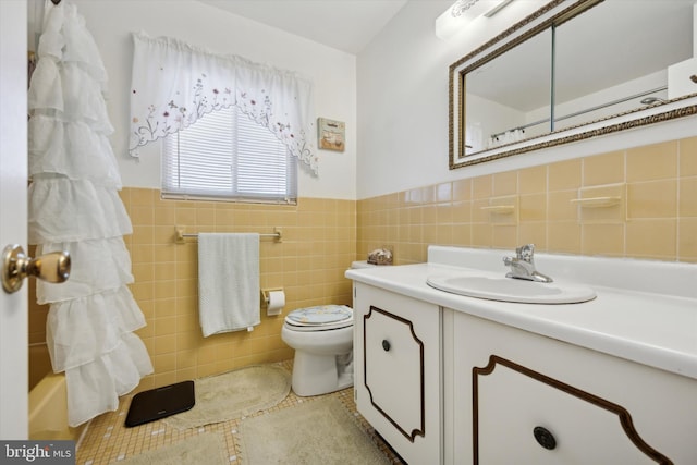 bathroom featuring tile walls, vanity, tile patterned flooring, and toilet