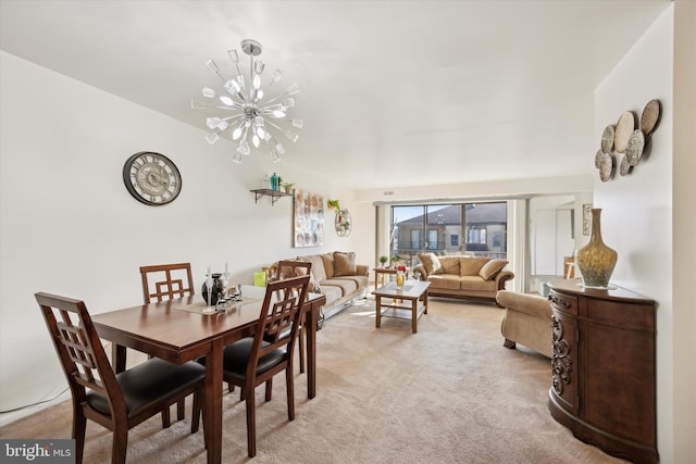 dining room featuring an inviting chandelier and light colored carpet