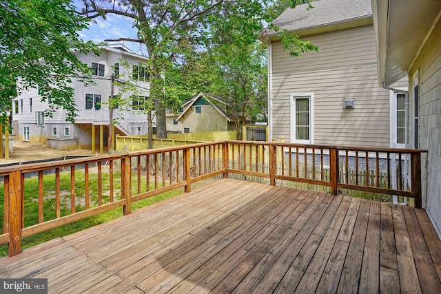 wooden terrace featuring a residential view and fence