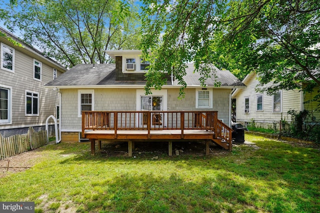 back of house featuring a shingled roof, fence private yard, a yard, and a deck