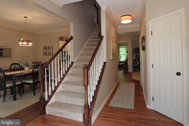 15516 Wigeon Way, Woodbridge, VA 22191 - staircase featuring wood finished floors, ornamental molding, a chandelier, and baseboards