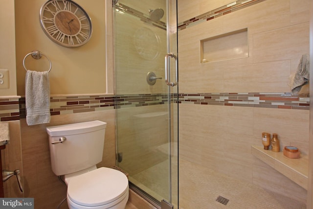 15516 Wigeon Way, Woodbridge, VA 22191 - full bathroom with a stall shower, tile walls, toilet, and wainscoting