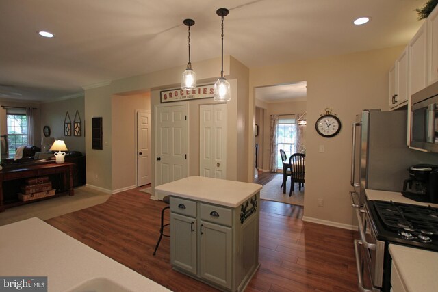 15516 Wigeon Way, Woodbridge, VA 22191 - kitchen with open floor plan, ornamental molding, light countertops, appliances with stainless steel finishes, and dark wood-style flooring