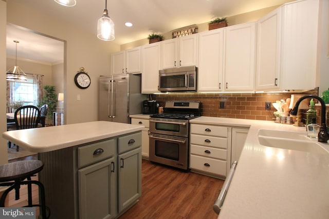 15516 Wigeon Way, Woodbridge, VA 22191 - kitchen featuring stainless steel appliances, a sink, light countertops, dark wood-style flooring, and ornamental molding