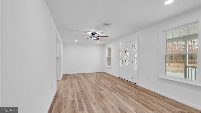 interior space with light wood-style floors, recessed lighting, visible vents, and baseboards