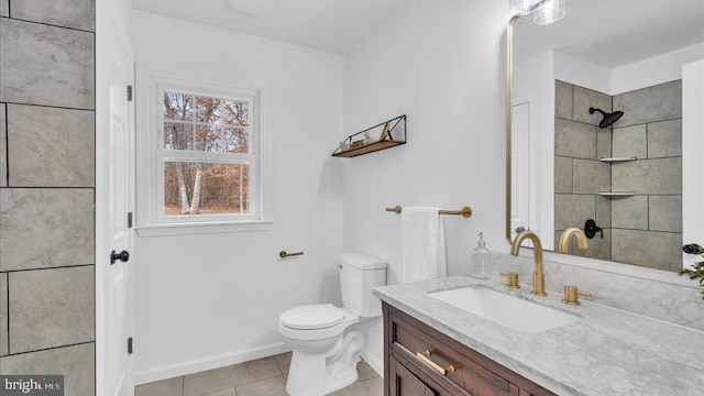 bathroom with tile patterned flooring, vanity, and toilet