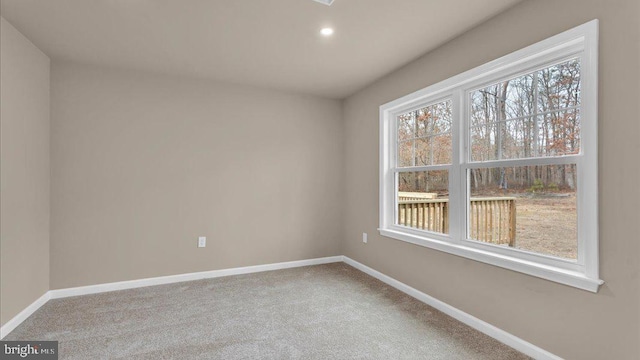 spare room with carpet, baseboards, and recessed lighting