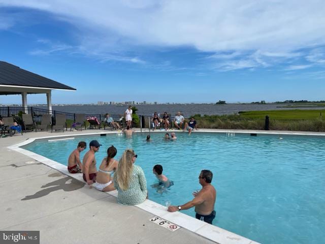 pool featuring fence and a patio