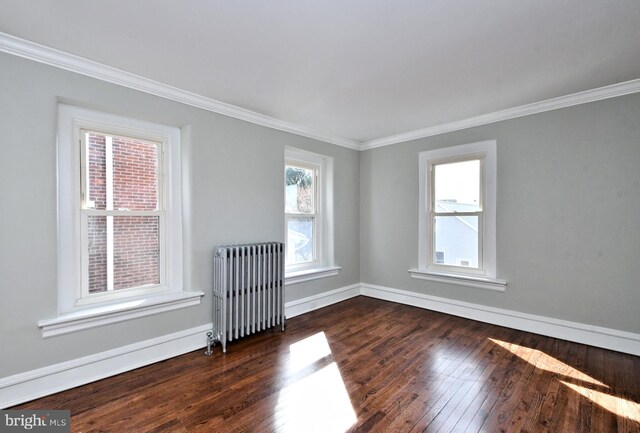 28 N 2nd St, Souderton, PA 18964 - spare room featuring ornamental molding, dark hardwood / wood-style floors, and radiator heating unit