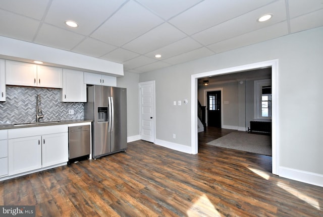 28 N 2nd St, Souderton, PA 18964 - kitchen with appliances with stainless steel finishes, sink, white cabinetry, dark wood-type flooring, and tasteful backsplash