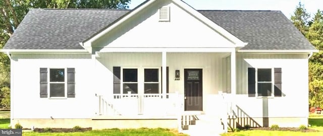 view of front of property featuring a shingled roof and covered porch