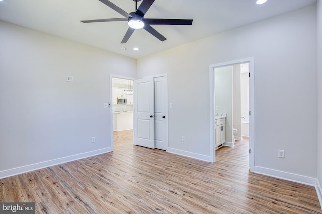 unfurnished bedroom with recessed lighting, light wood-style floors, and baseboards
