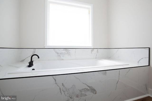 full bathroom with plenty of natural light and a bath