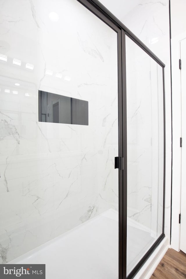 bathroom with a marble finish shower