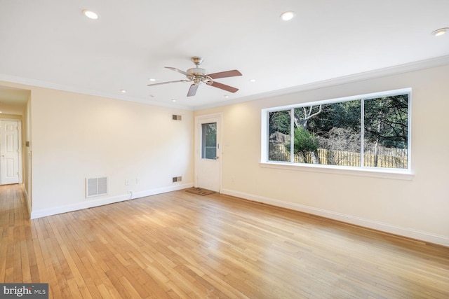 empty room with light wood-type flooring, ornamental molding, and ceiling fan