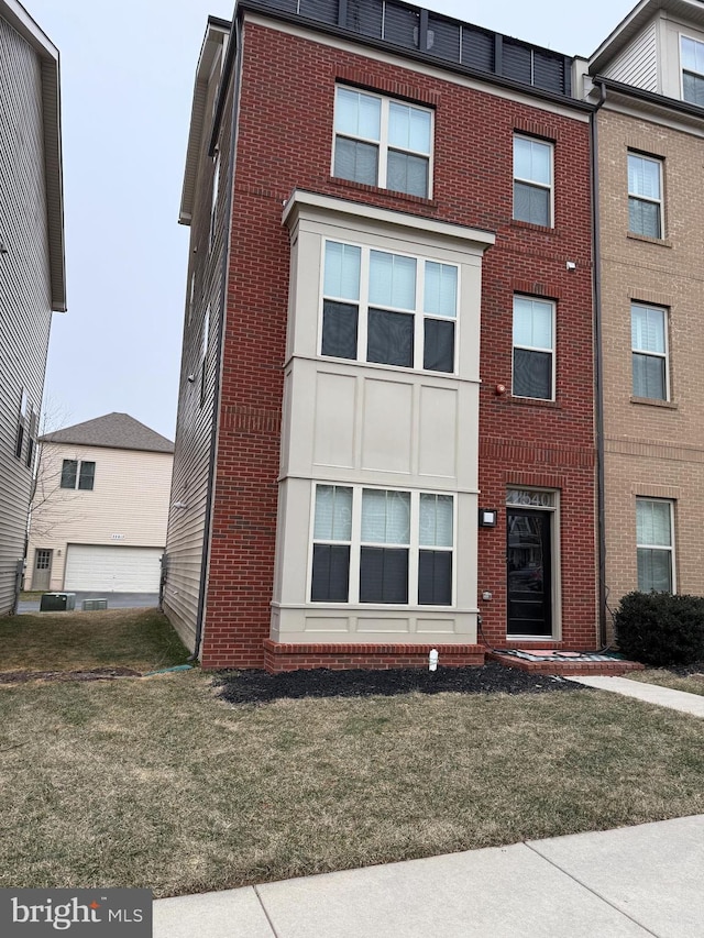 view of front of property with a front yard and brick siding