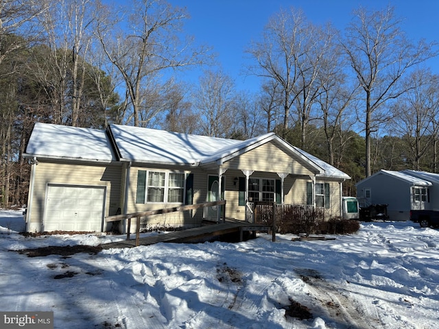 single story home featuring covered porch and a garage