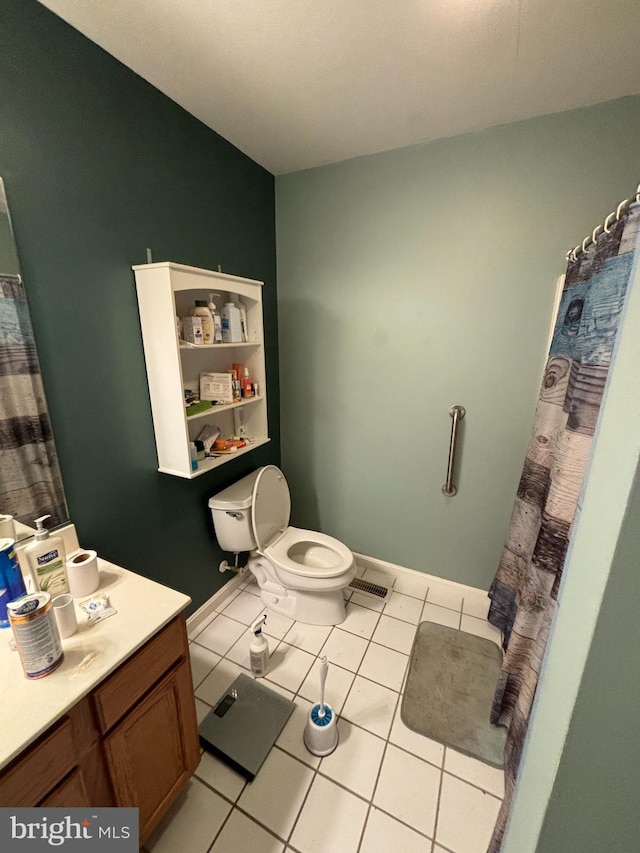 bathroom featuring tile patterned floors, toilet, and vanity