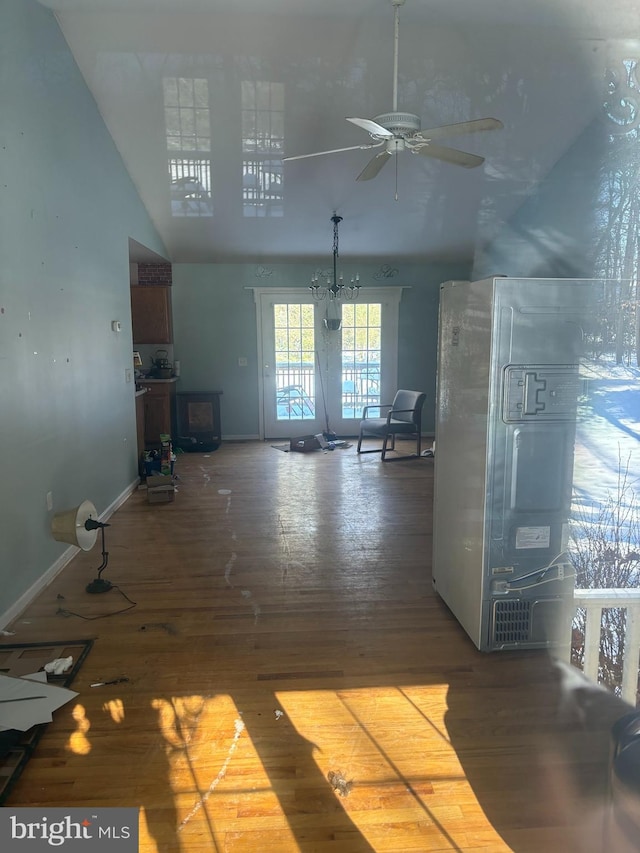 unfurnished living room featuring a high ceiling and hardwood / wood-style flooring