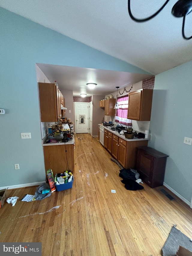 kitchen with light wood-type flooring and lofted ceiling