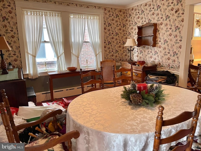 dining space featuring baseboard heating and crown molding