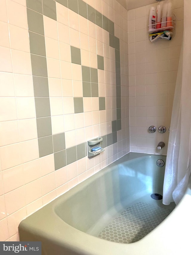 bathroom with shower / bath combination with curtain