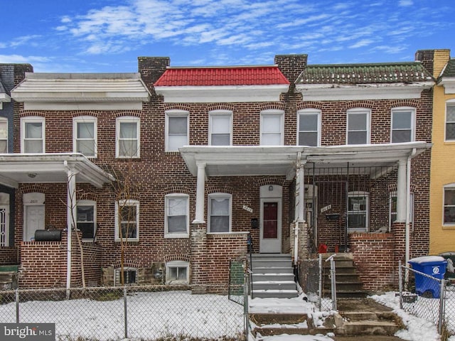 townhome / multi-family property with central air condition unit and brick siding