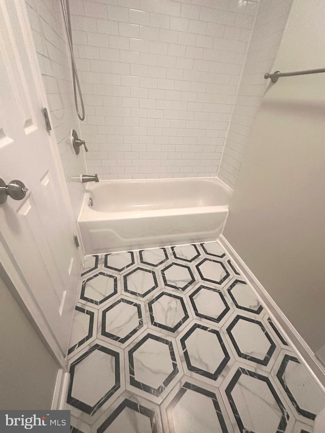 full bathroom featuring baseboards, shower / tub combination, and tile patterned flooring