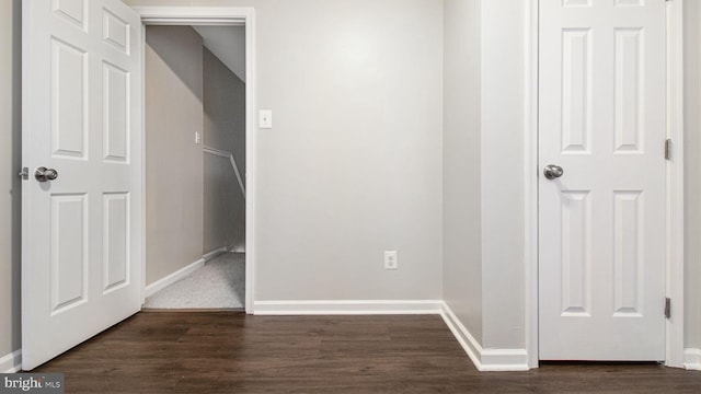 unfurnished bedroom featuring baseboards and dark wood-style floors