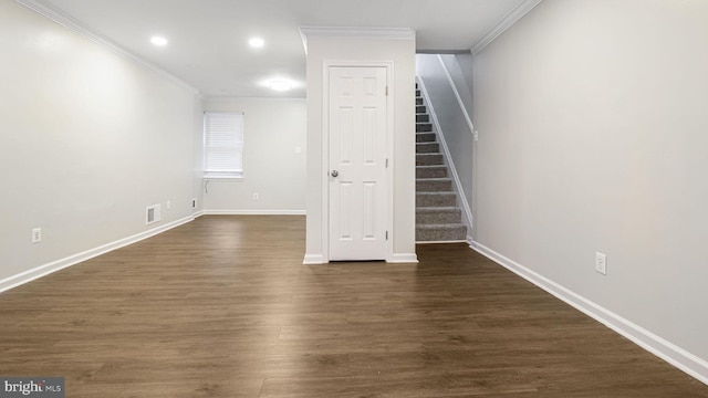 interior space with stairway, visible vents, dark wood finished floors, and crown molding