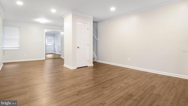 unfurnished room featuring baseboards, ornamental molding, dark wood-style flooring, and recessed lighting